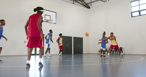 Young Athletes Playing Indoor Basketball Game