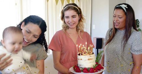 Women Celebrating 30th Birthday Holding Rustic Strawberry Cake with Baby and Confetti