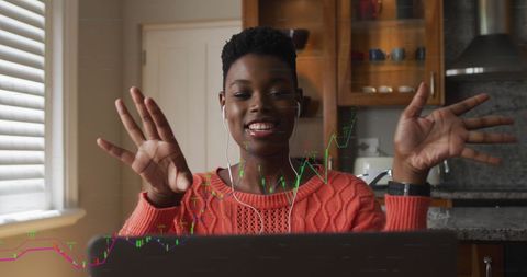 Cheerful Woman Analyzing Financial Data on Laptop
