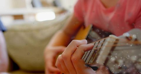 Girl Practicing Guitar with Soothing Ambient Lights