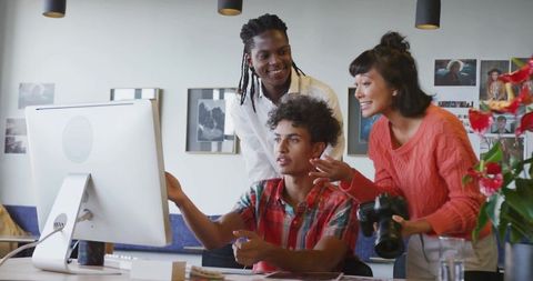 Creative team collaborating on digital design project in studio