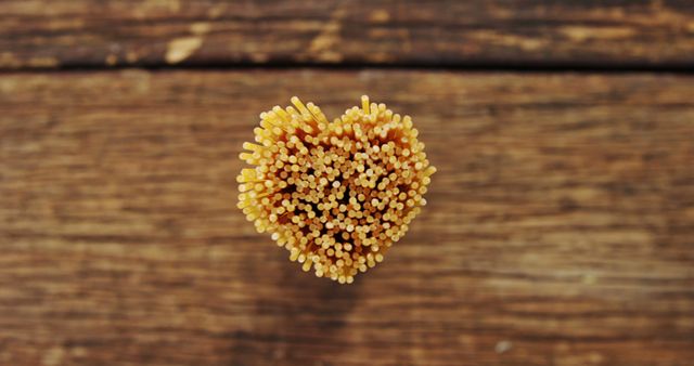 Spaghetti Noodles Forming Heart Shape on Wooden Surface - Download Free Stock Images Pikwizard.com