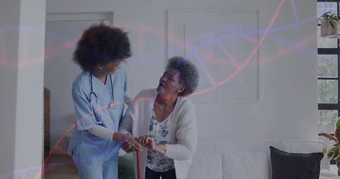 Home caregiver supporting senior woman with red cane, nurse steadying elder in living room