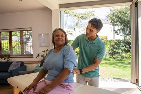 Senior Woman Receiving Therapy from Caring Therapist in Bright Room