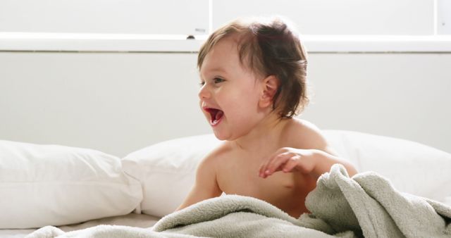 Cute baby playing on a bed at home 