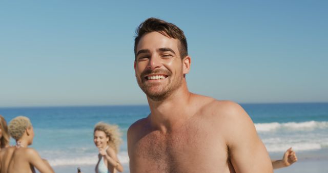 Smiling Man Enjoying Beach Day with Friends - Download Free Stock Images Pikwizard.com