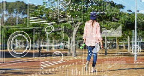 Walking woman wearing pink jacket and cap with hud data overlay on urban promenade