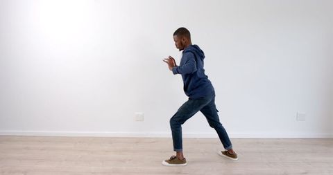 Man Practicing Martial Arts at Home for Fitness and Self-Defense - Download Free Stock Images Pikwizard.com