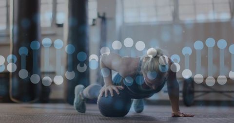 Female athlete performing medicine-ball push-up showing balance, core strength, functional fitness