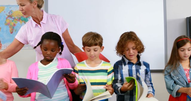 Diverse Group of Young Students Reading Together in Classroom - Download Free Stock Images Pikwizard.com