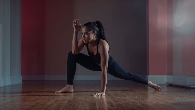 Woman in Sporty Outdoor Dance Pose on Hardwood Floor