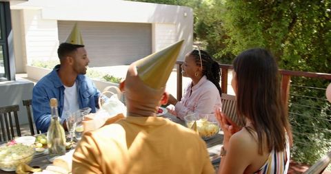 Cheerful Friends at Outdoor Birthday Party Celebrating