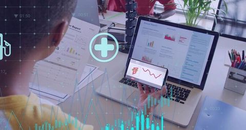 Team Reviewing Annual Reports on Laptop and Smartphone with Interactive Data Visualizations