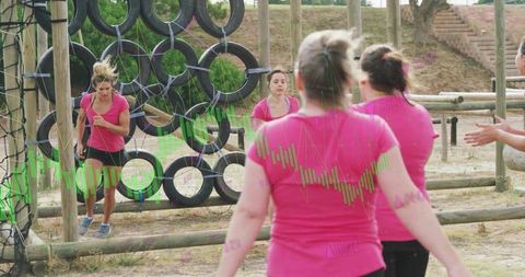 Women training in obstacle course racing in team spirit