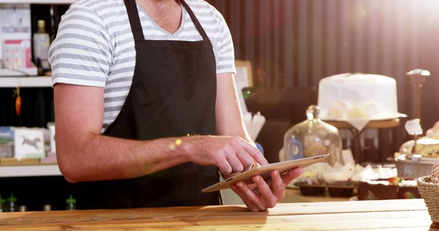 Barista Prepares Coffee Order Using Tablet in Cafe - Download Free Stock Images Pikwizard.com