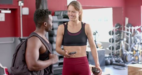 Diverse Fitness Enthusiasts Connecting at Trendy Gym