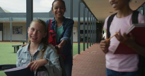Diverse Schoolgirls Walking and Laughing in School Corridor - Download Free Stock Images Pikwizard.com