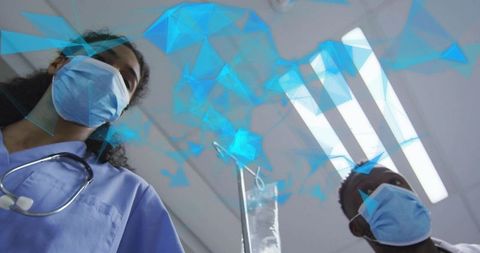 Medical team leaning over patient with iv drip and blue digital network overlay