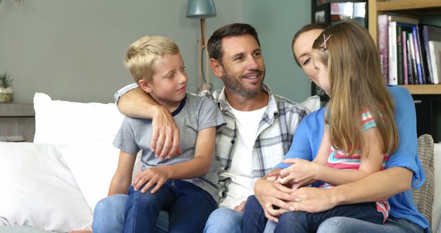 Happy Family of Four Relaxing on Couch Together - Download Free Stock Images Pikwizard.com