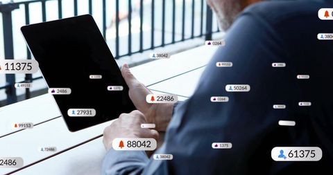 Man Tapping Tablet on Balcony with Floating Notification Badges, Social Media Interface