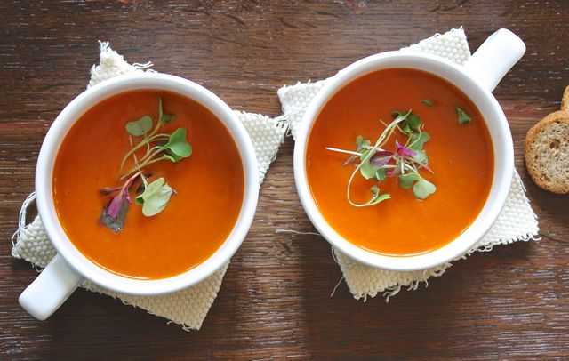 Two Bowls of Tomato Soup with Microgreens Garnish on Rustic Table - Download Free Stock Photos Pikwizard.com