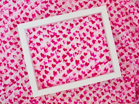 Blank frame with vibrant heart pattern background