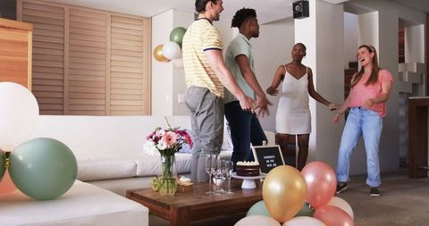 Friends Celebrating at Home Exchanging Gifts and Enjoying