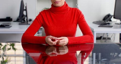 Businesswoman Gesturing Leadership in Red Sweater Office Meeting
