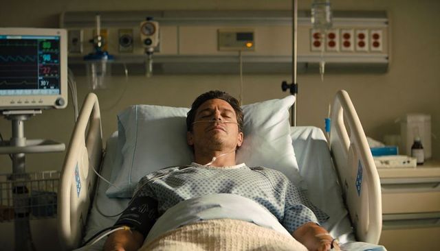 Male patient resting in hospital bed with nasal cannula, iv drip and cardiac monitor