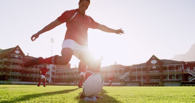 Low angle view of Caucasian rugby player kicking the ball from the kicking tee in the stadium. He is kicking penalty 4k