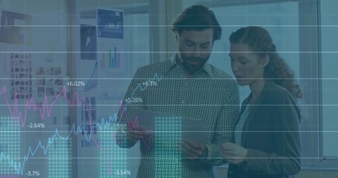 Office Colleagues Analyzing Financial Graphs and Reports