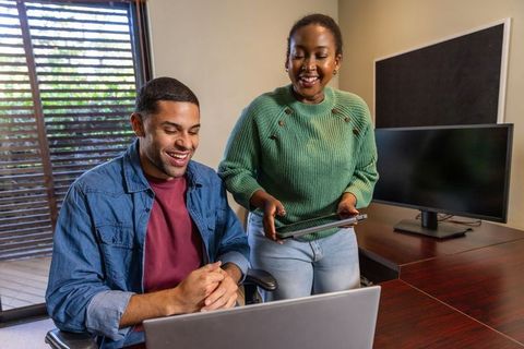 Diverse coworkers discussing work in home office environment