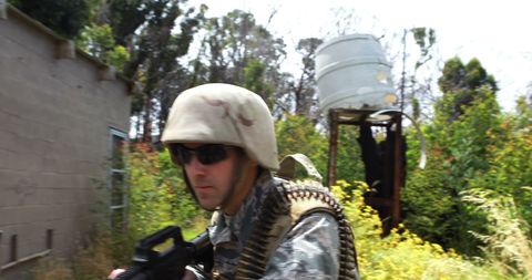 Focused Military Personnel Patrolling Green Area with Weaponry - Download Free Stock Images Pikwizard.com