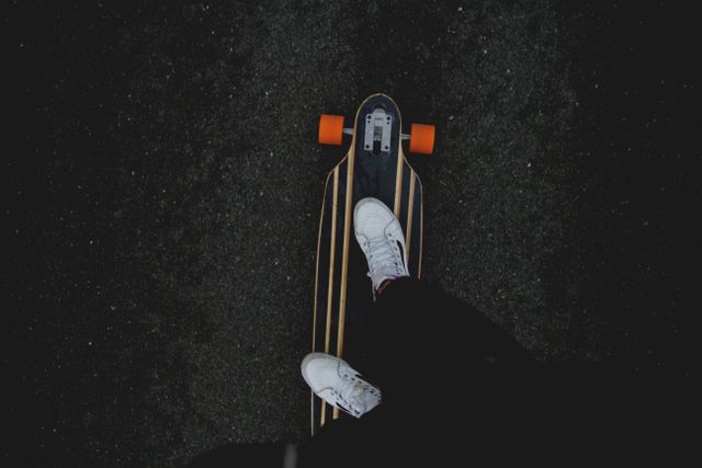 Low section of man riding a Skateboard on the street. adventure sports and Skateboarding concept 