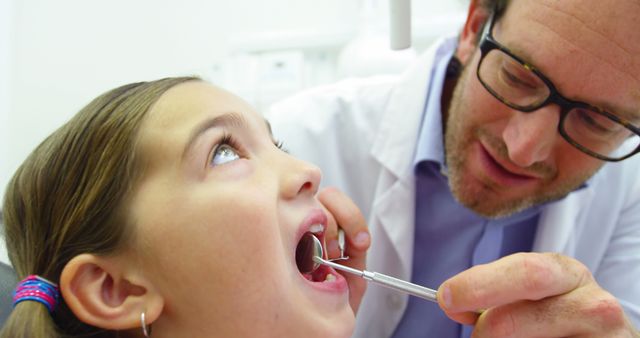 Dentist examining a young patient with dental tools in dental clinic 4k