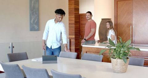 Diverse Friends Laughing and Socializing in Modern Kitchen