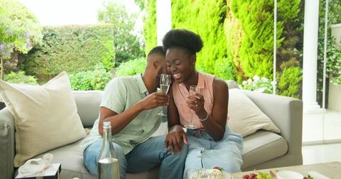 Couple Enjoying Drinks on Cozy Outdoor Patio