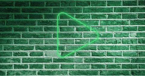 Glowing Neon Arrow Icon on Green Brick Wall - Download Free Stock Images Pikwizard.com
