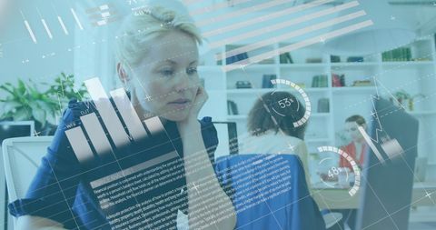 Focused businesswoman analyzing data infographics in office