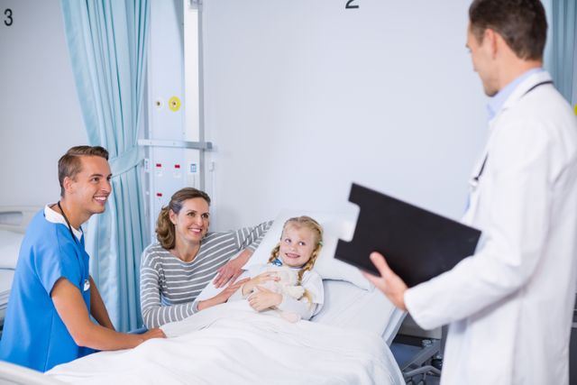 Doctor talking to girl patient in hospital bed - Download Free Stock Photos Pikwizard.com