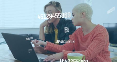 Diverse Female Colleagues Analyzing Data on Laptop