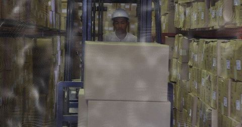 Warehouse Worker Operating Forklift with Proper Safety Gear