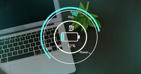 Low battery hud overlay on laptop workspace with succulent and modern teal interface