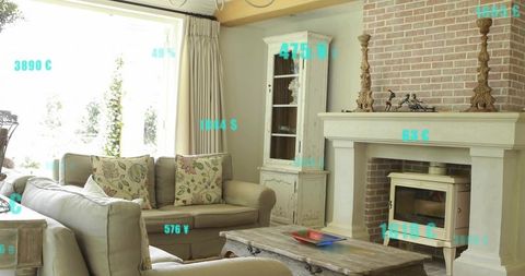 Sunlit rustic living room featuring beige sofa with floral pillows, brick fireplace & cabinet