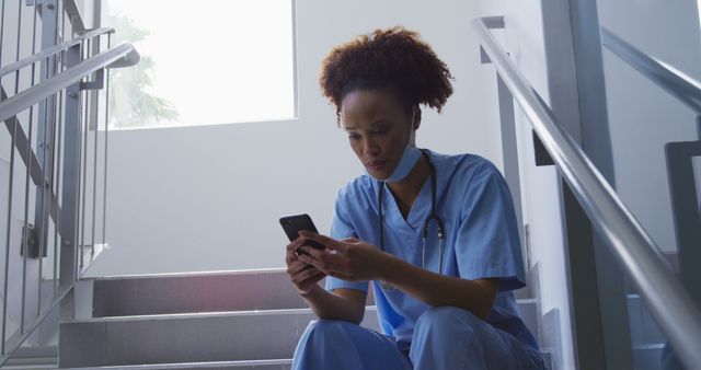 Nurse Taking a Break on Stairwell Checking Phone in Hospital Setting - Download Free Stock Images Pikwizard.com