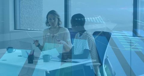 Businesswomen Discussing Documents in Modern Office Environment