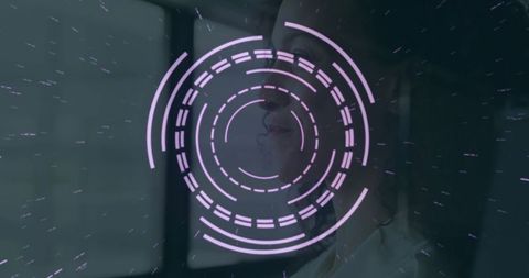 Woman studying futuristic holographic interface in dark room