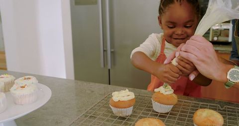 Mother and Daughter Baking Cupcakes Together in Cozy Kitchen Scene
