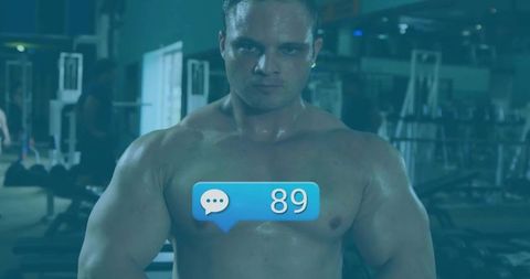 Shirtless Muscular Athlete in Gym with Social Media Notification