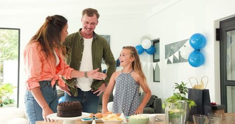 Happy Family Celebrating Birthday at Home with Cake and Balloons